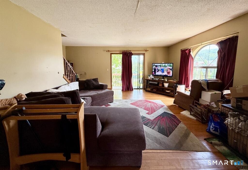 817 Woodtick Road, Unit A Waterbury, CT 06705 - Photo 5 of 16 a living room with furniture and a flat screen tv