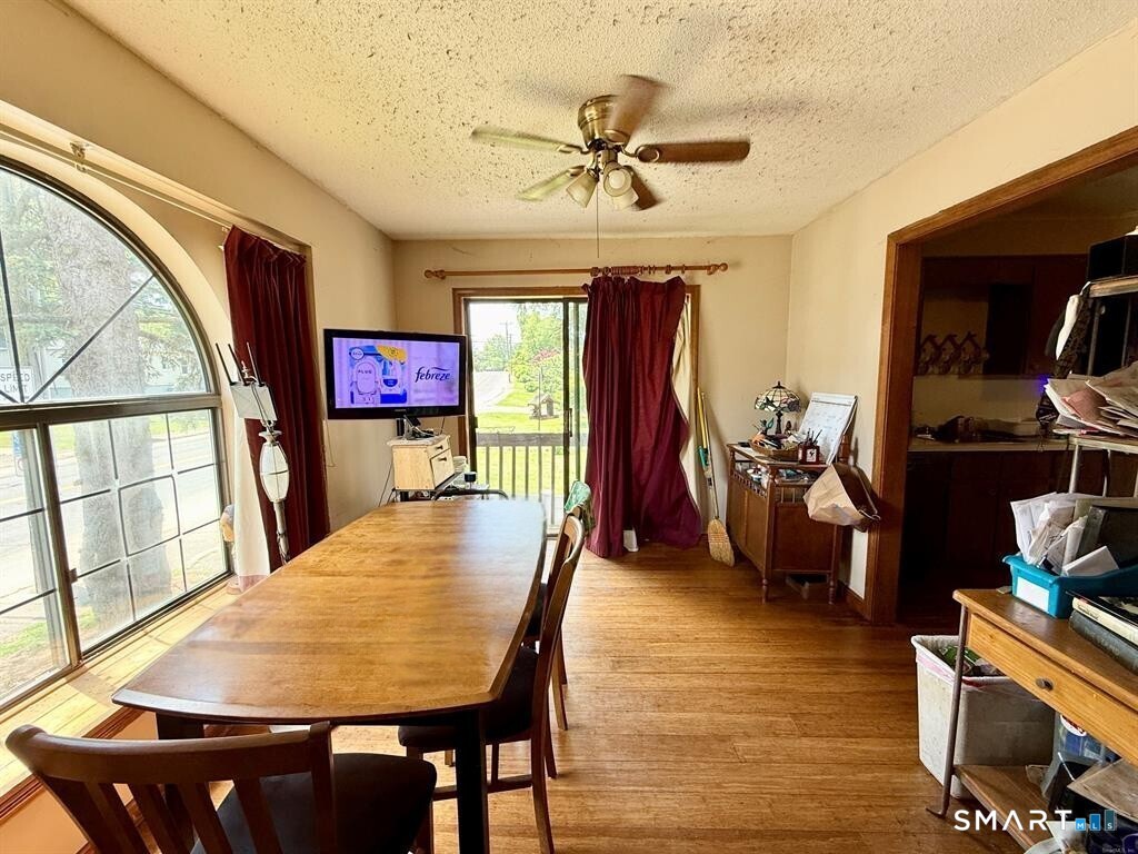 817 Woodtick Road, Unit A Waterbury, CT 06705 - Photo 7 of 16 a view of a dining room with furniture window and wooden floor