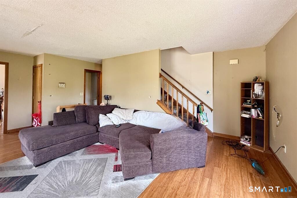 817 Woodtick Road, Unit A Waterbury, CT 06705 - Photo 10 of 16 a living room with furniture and wooden floor
