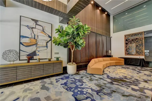 a bedroom with a bed and a potted plant on the dresser