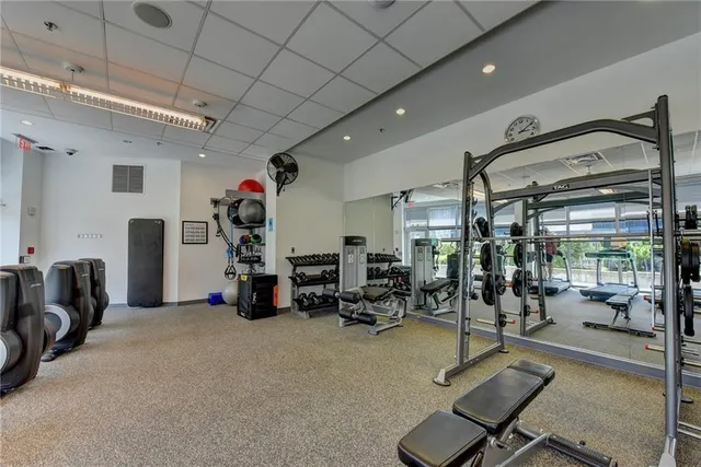 a room with gym equipment and a table