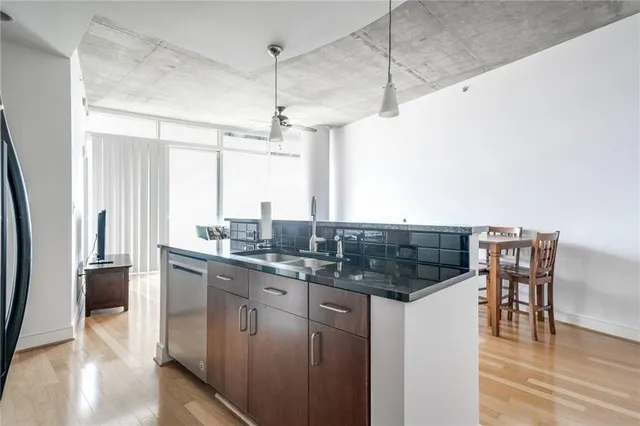 a kitchen with a counter space a sink appliances and cabinets