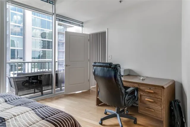 a view of a workspace with furniture and a window