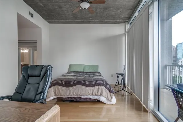 a bedroom with a bed and wooden floor
