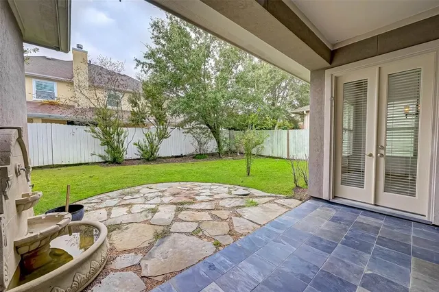 a view of an house with backyard space and a garden
