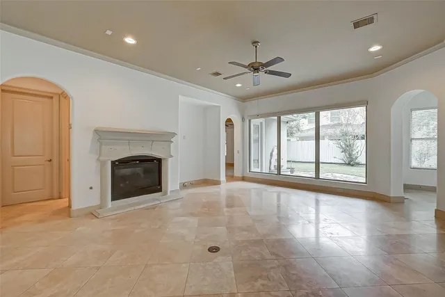 a view of an empty room with a fireplace and a window