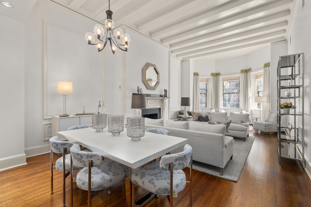 113 Commonwealth Avenue, Unit 3 Boston, MA 02116 - Photo 11 of 30 a view of a dining room with furniture a chandelier and wooden floor
