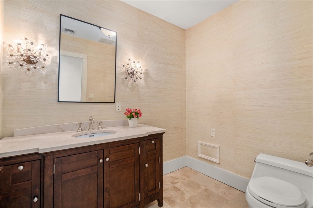 113 Commonwealth Avenue, Unit 3 Boston, MA 02116 - Photo 17 of 30 a bathroom with a toilet a sink and mirror