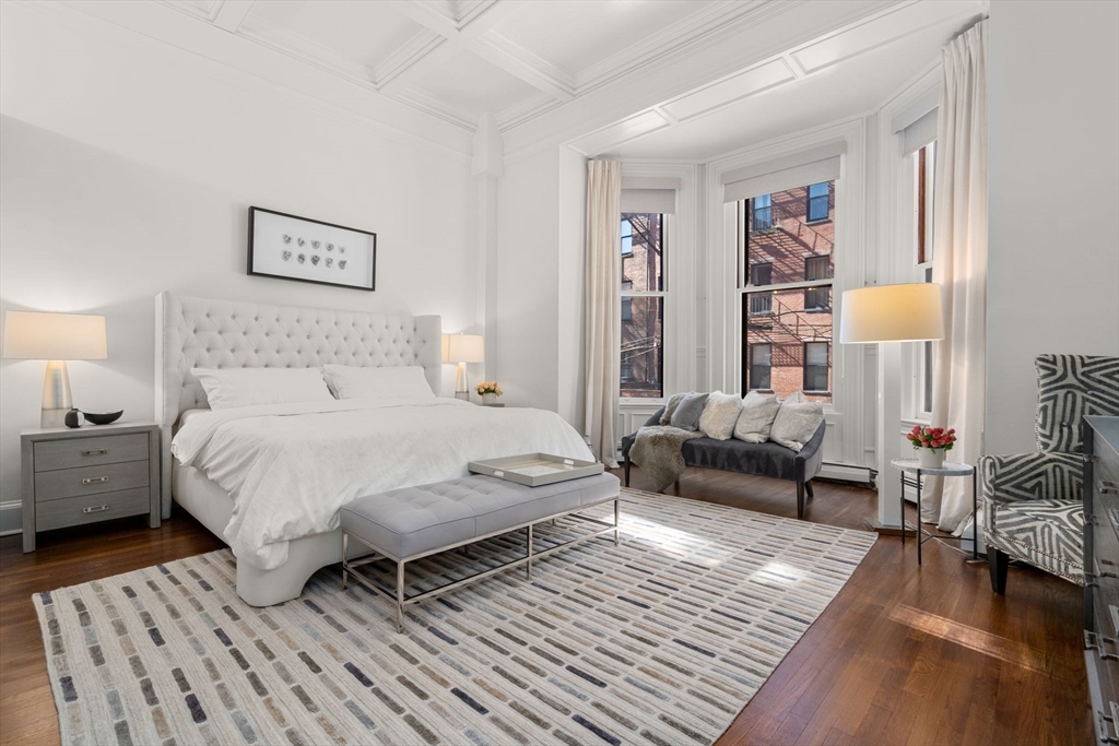 113 Commonwealth Avenue, Unit 3 Boston, MA 02116 - Photo 21 of 30 a spacious bedroom with a bed a couch and a window