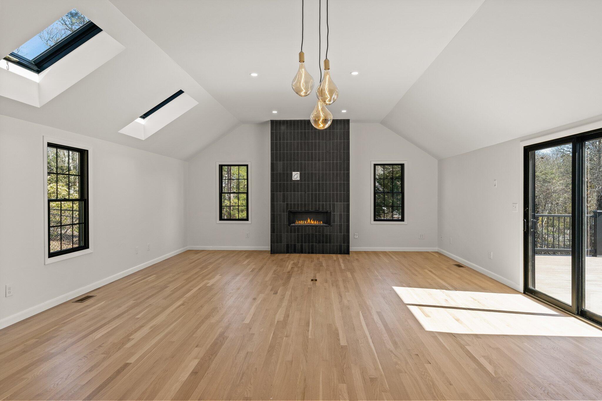 101 Monomoyic Way Chatham, MA 02633 - Photo 12 of 59 a view of an empty room with window and wooden floor
