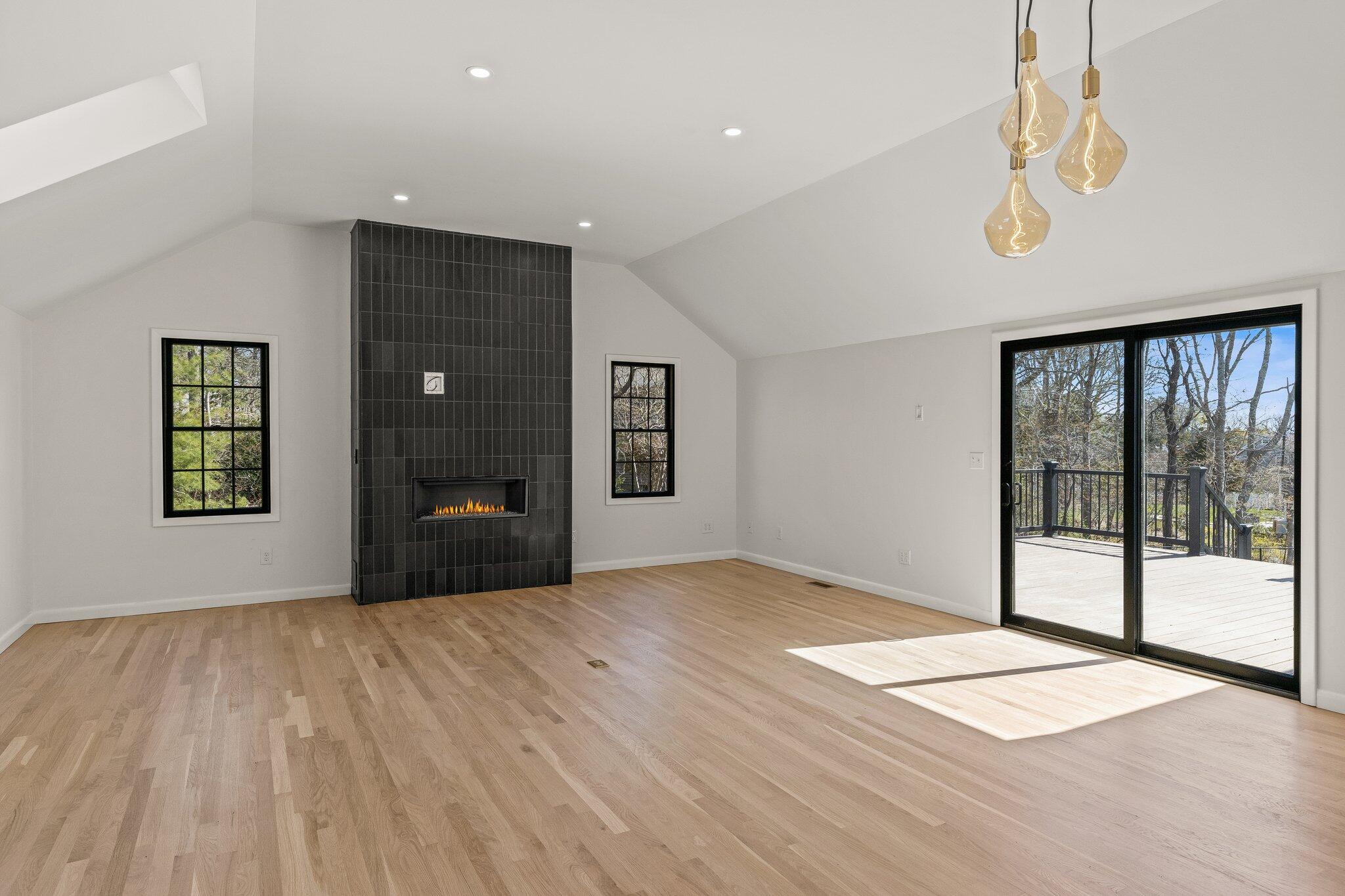 101 Monomoyic Way Chatham, MA 02633 - Photo 13 of 59 a view of an empty room with a window and wooden floor