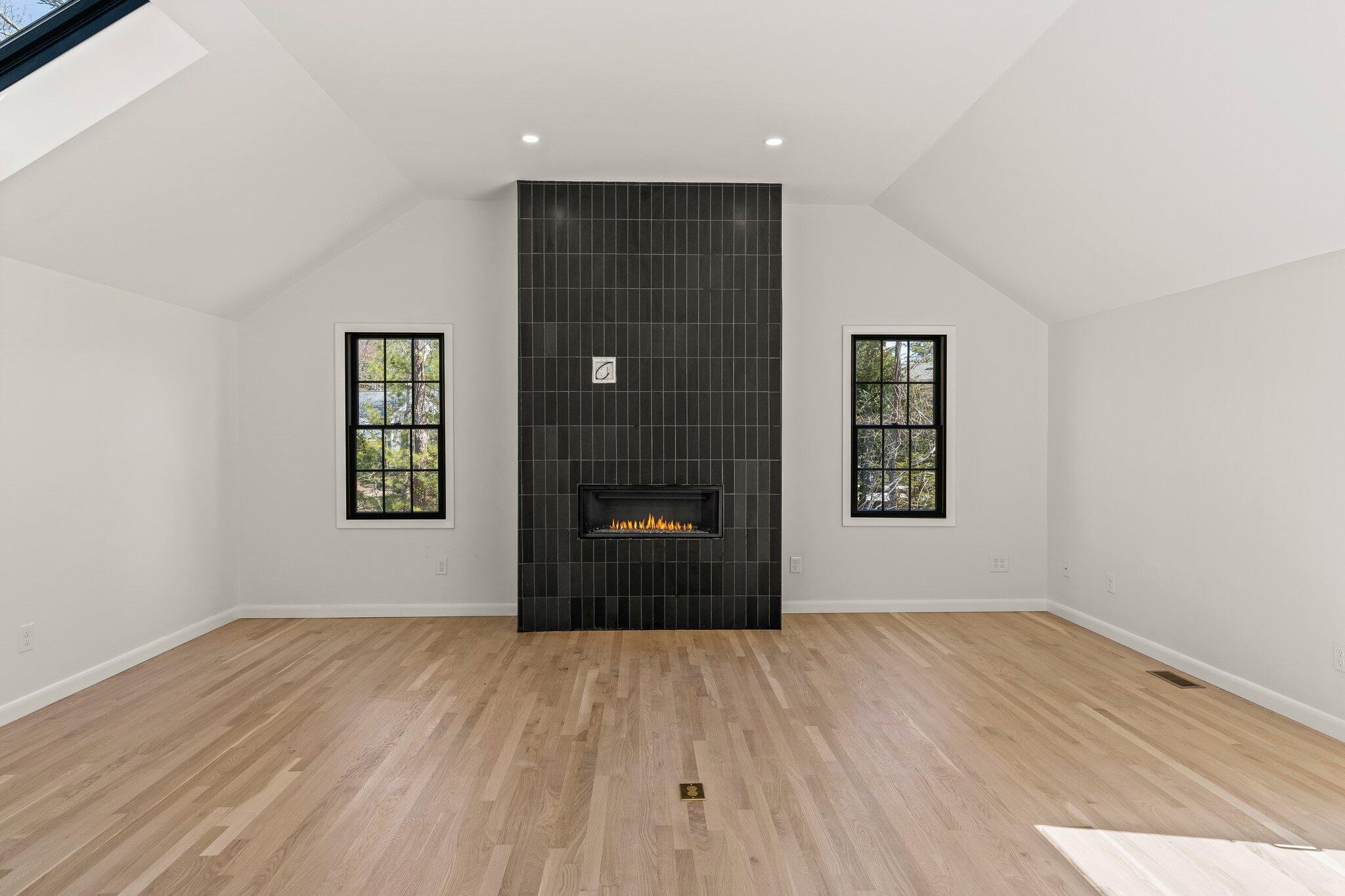 101 Monomoyic Way Chatham, MA 02633 - Photo 14 of 59 a view of a room with wooden floor and a fireplace