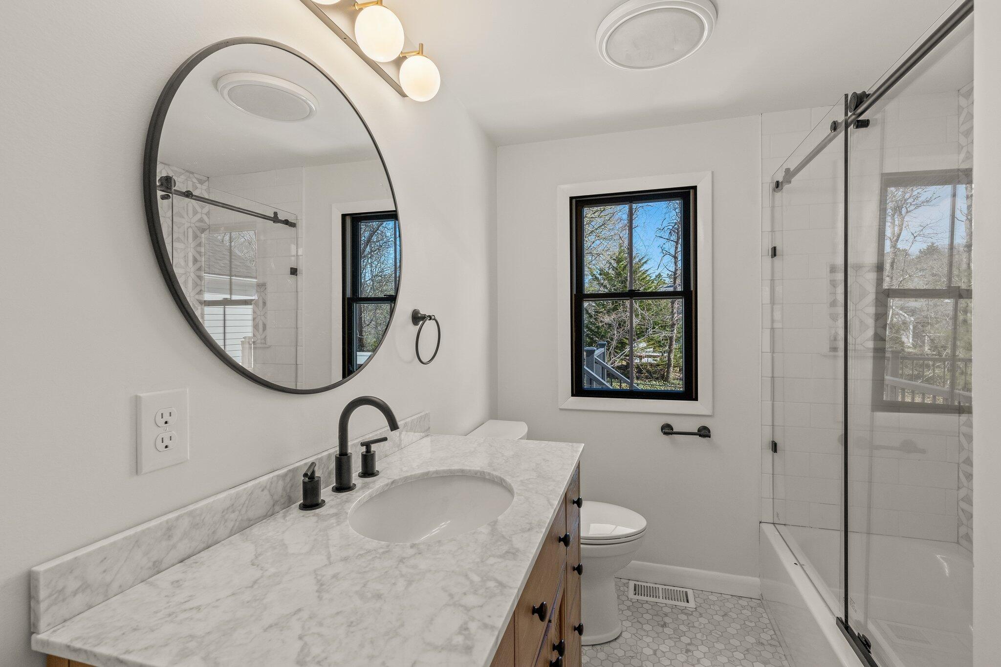 101 Monomoyic Way Chatham, MA 02633 - Photo 20 of 59 a bathroom with a sink a toilet and a mirror