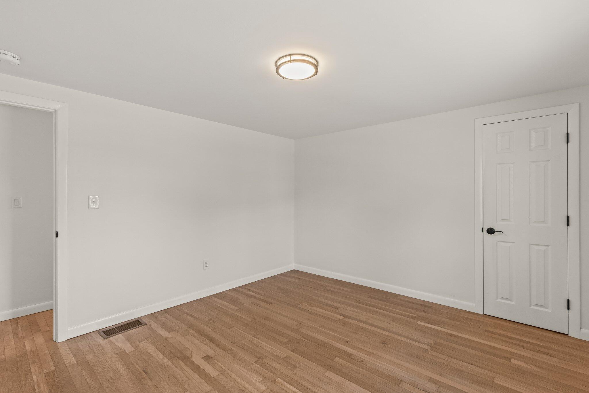 101 Monomoyic Way Chatham, MA 02633 - Photo 22 of 59 a view of an empty room with wooden floor