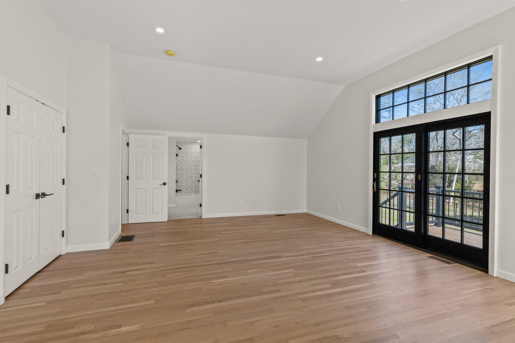 101 Monomoyic Way Chatham, MA 02633 - Photo 27 of 59 a view of an empty room with window and wooden floor