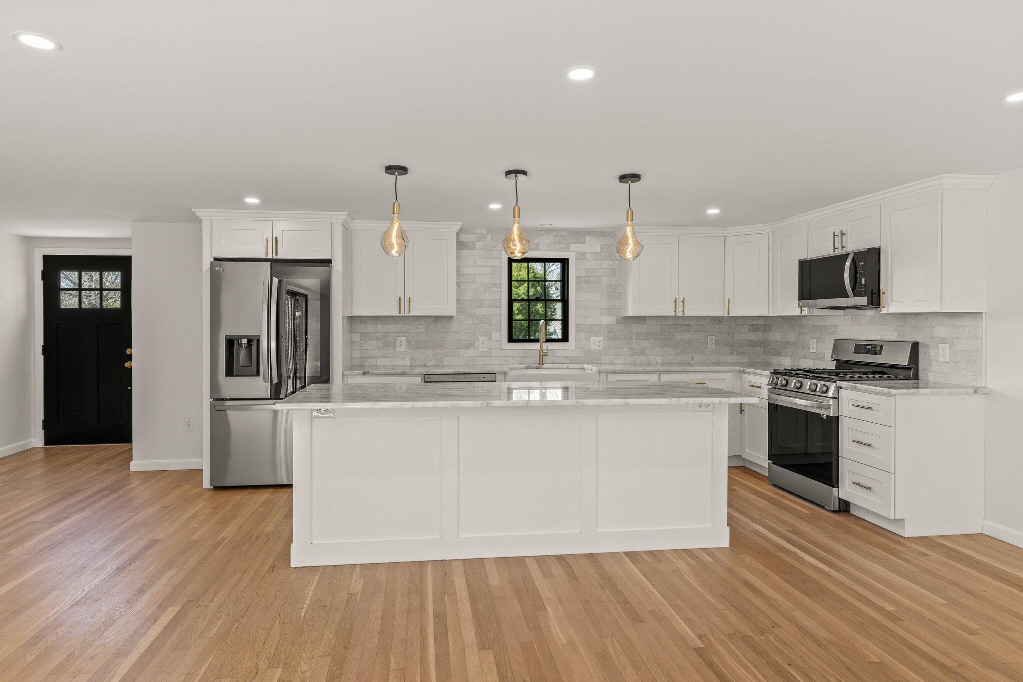 101 Monomoyic Way Chatham, MA 02633 - Photo 3 of 59 a large kitchen with stainless steel appliances granite countertop a stove a sink and a refrigerator