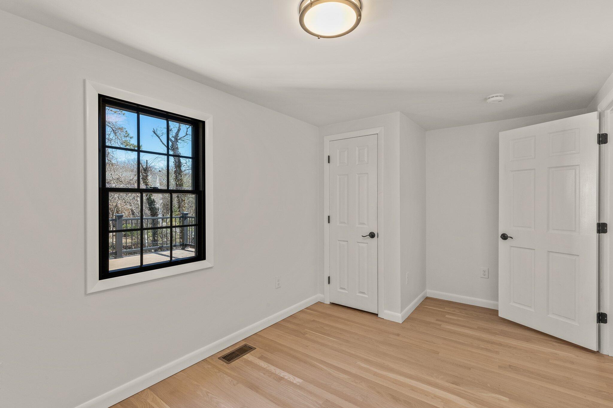 101 Monomoyic Way Chatham, MA 02633 - Photo 32 of 59 a view of an empty room with wooden floor and a window