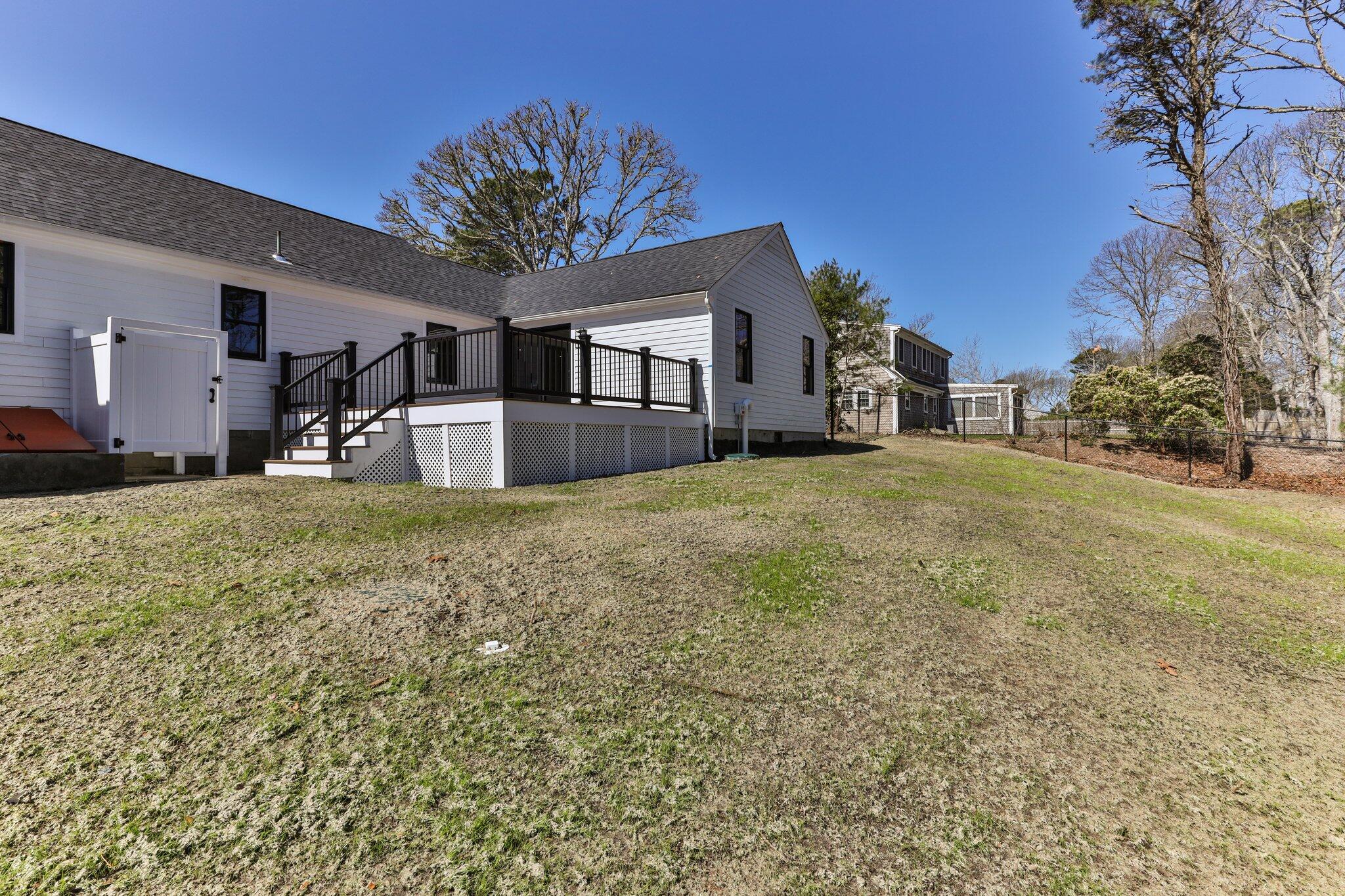 101 Monomoyic Way Chatham, MA 02633 - Photo 34 of 59 a view of a house with a yard