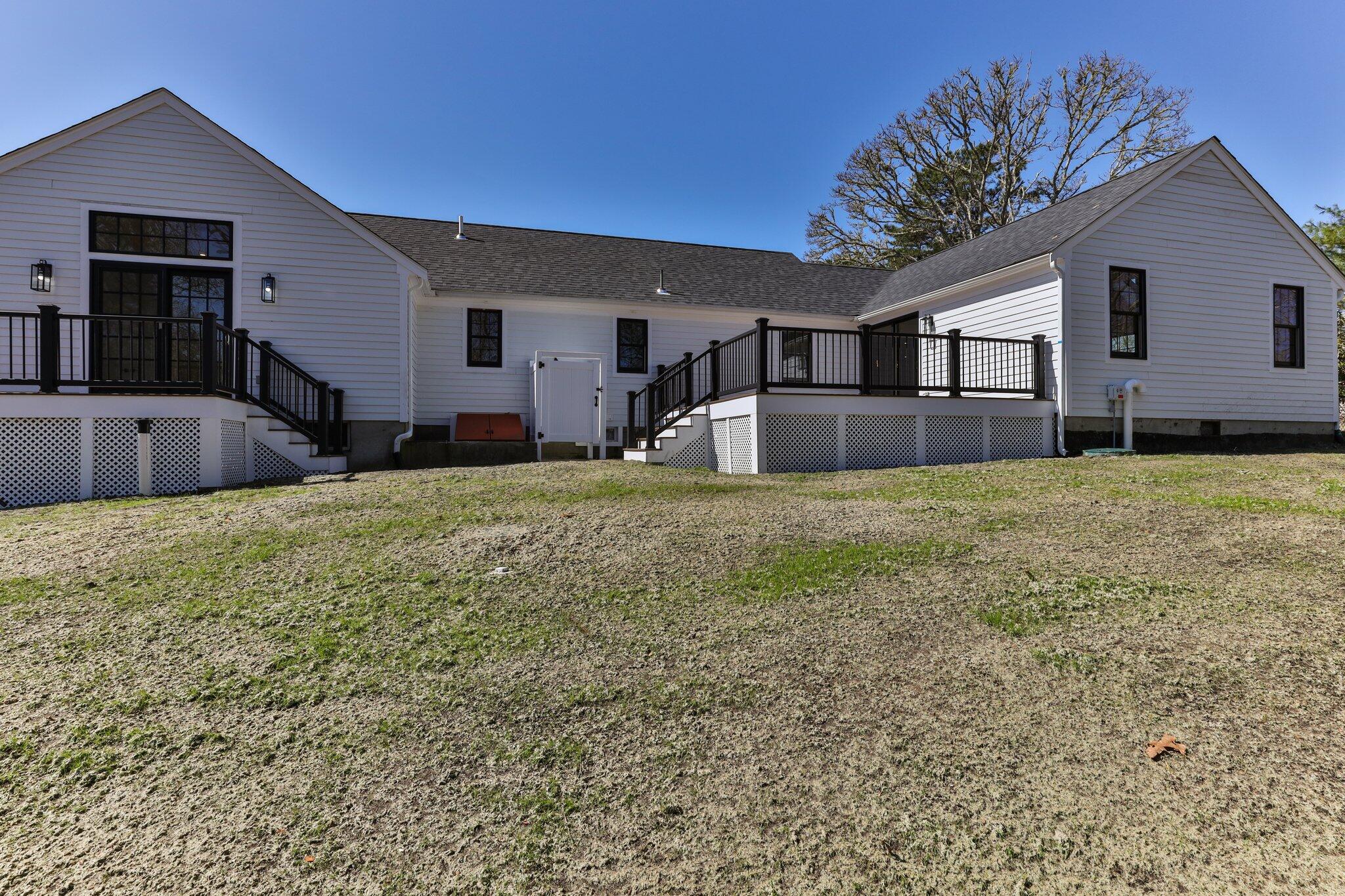 101 Monomoyic Way Chatham, MA 02633 - Photo 35 of 59 a large house with a large pool and large trees