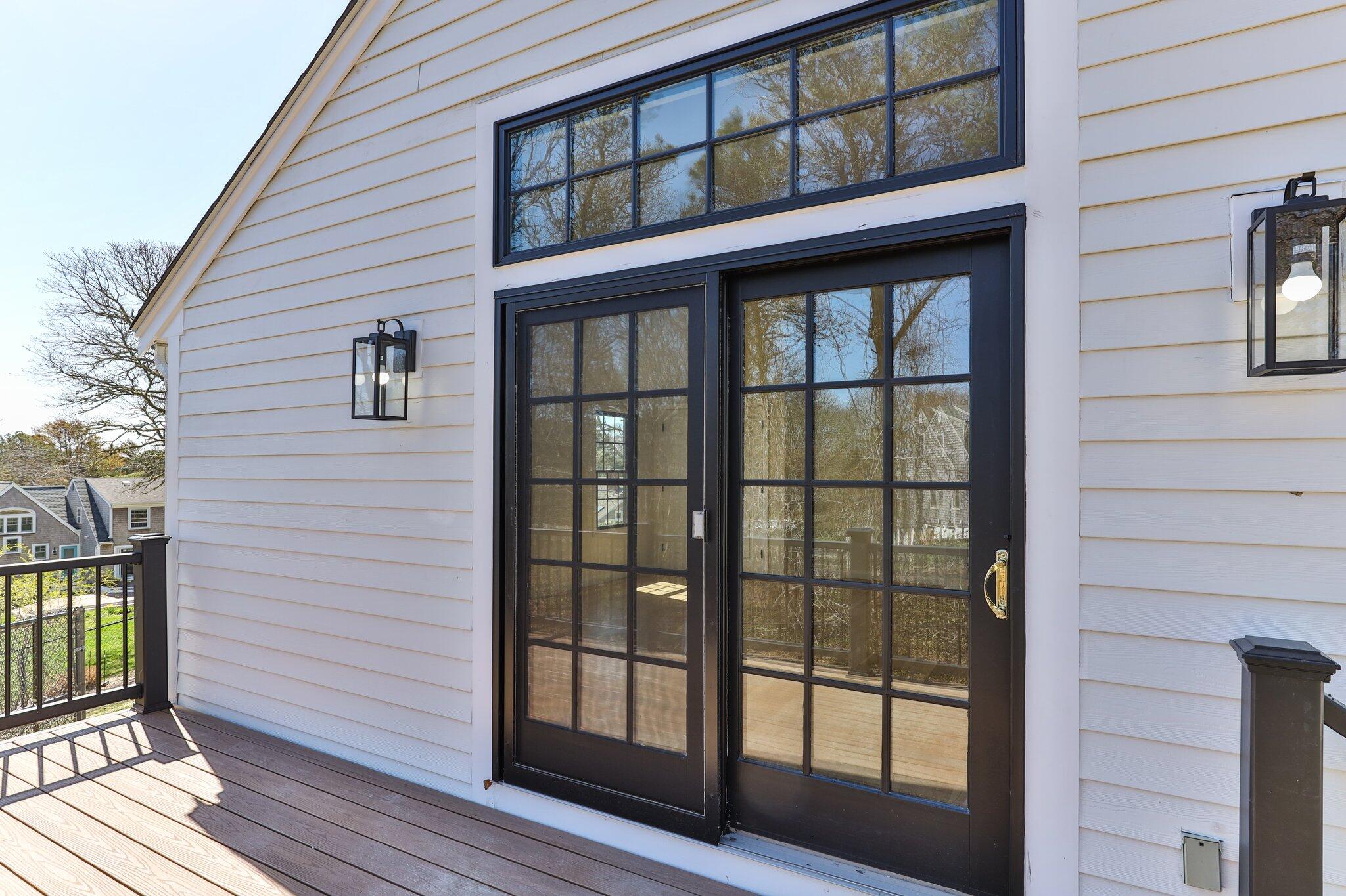 101 Monomoyic Way Chatham, MA 02633 - Photo 39 of 59 a view of a brick house with large windows