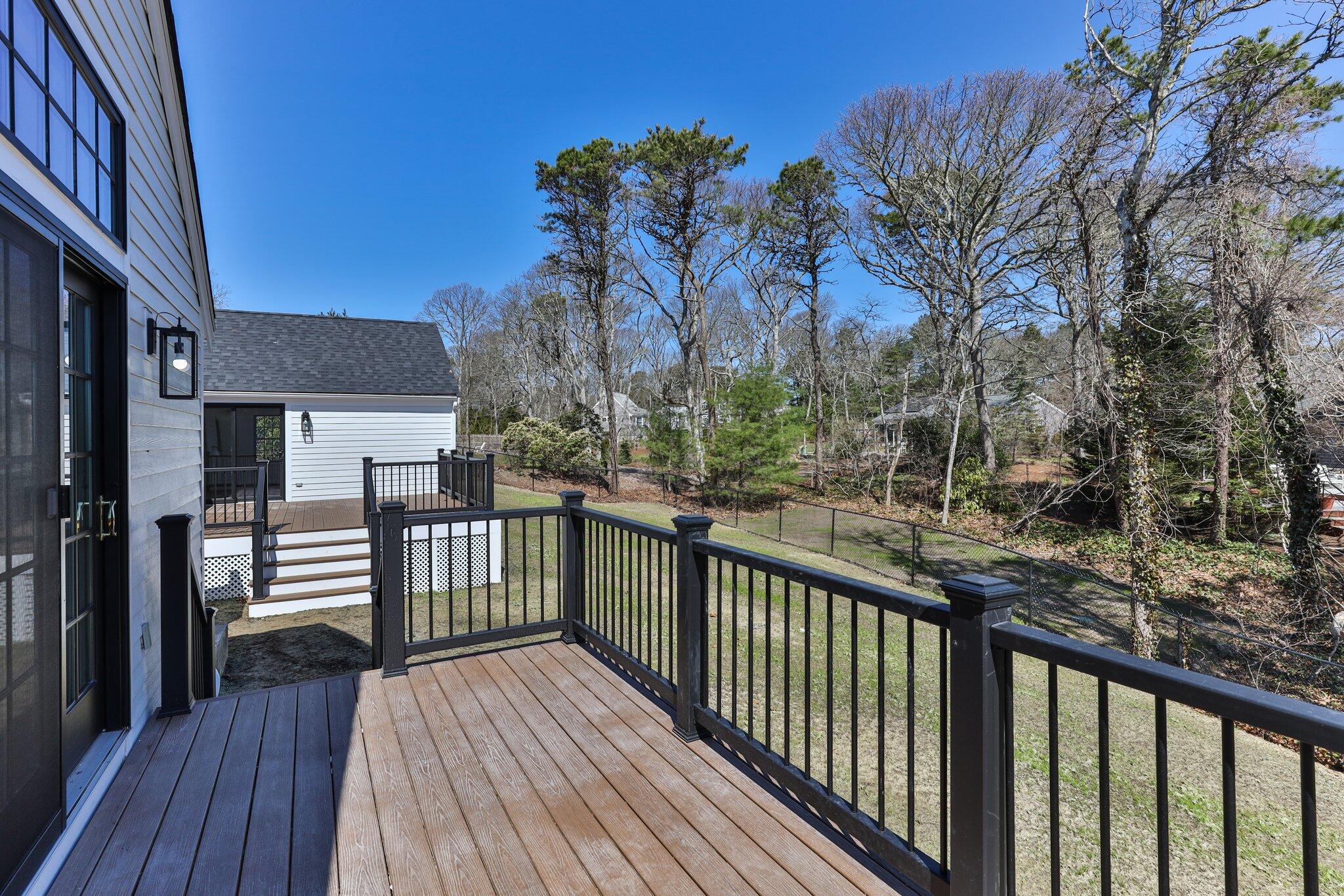 101 Monomoyic Way Chatham, MA 02633 - Photo 40 of 59 a view of a balcony with wooden floor and fence