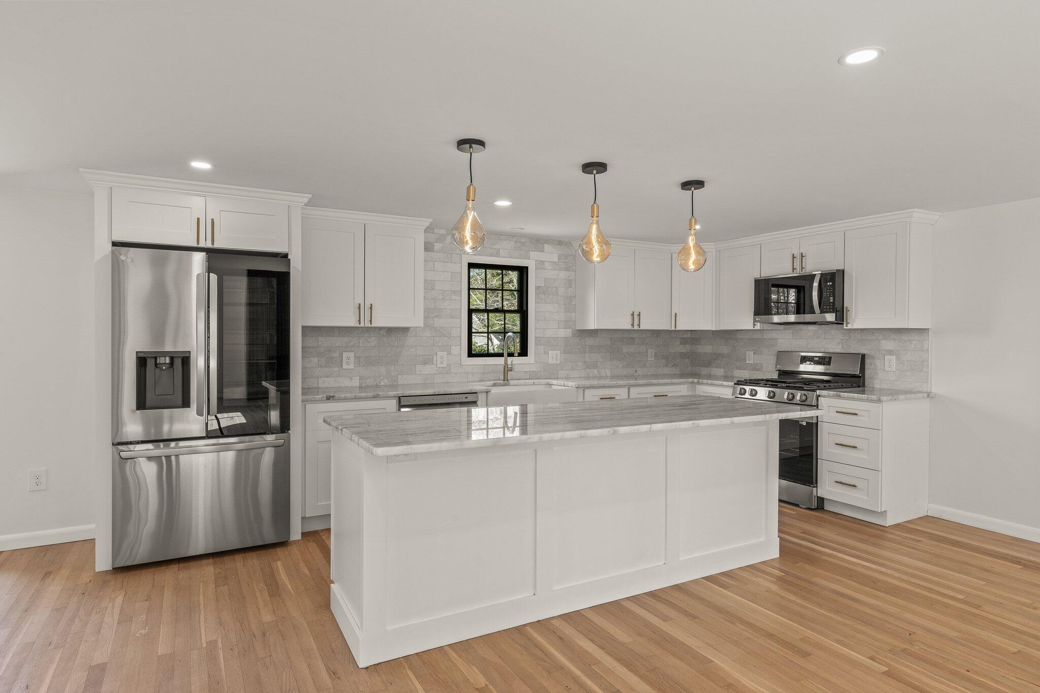 101 Monomoyic Way Chatham, MA 02633 - Photo 6 of 59 a kitchen with stainless steel appliances granite countertop a sink stove and refrigerator