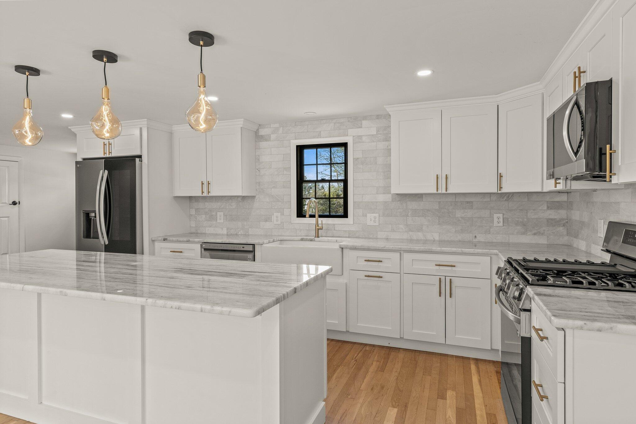 101 Monomoyic Way Chatham, MA 02633 - Photo 7 of 59 a kitchen with stainless steel appliances granite countertop a sink a stove a refrigerator and cabinets