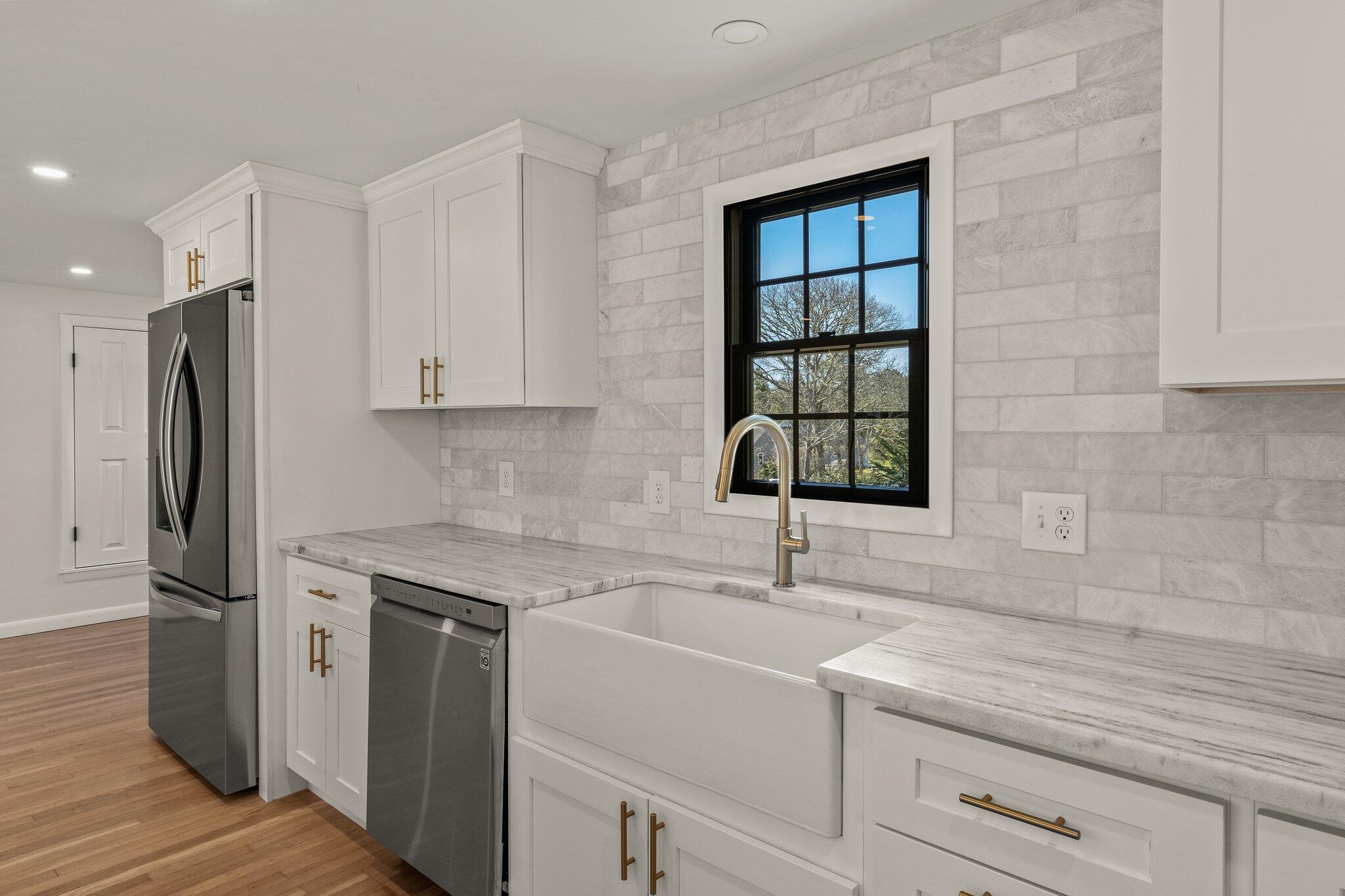 101 Monomoyic Way Chatham, MA 02633 - Photo 8 of 59 a kitchen with a sink cabinets stainless steel appliances and a window
