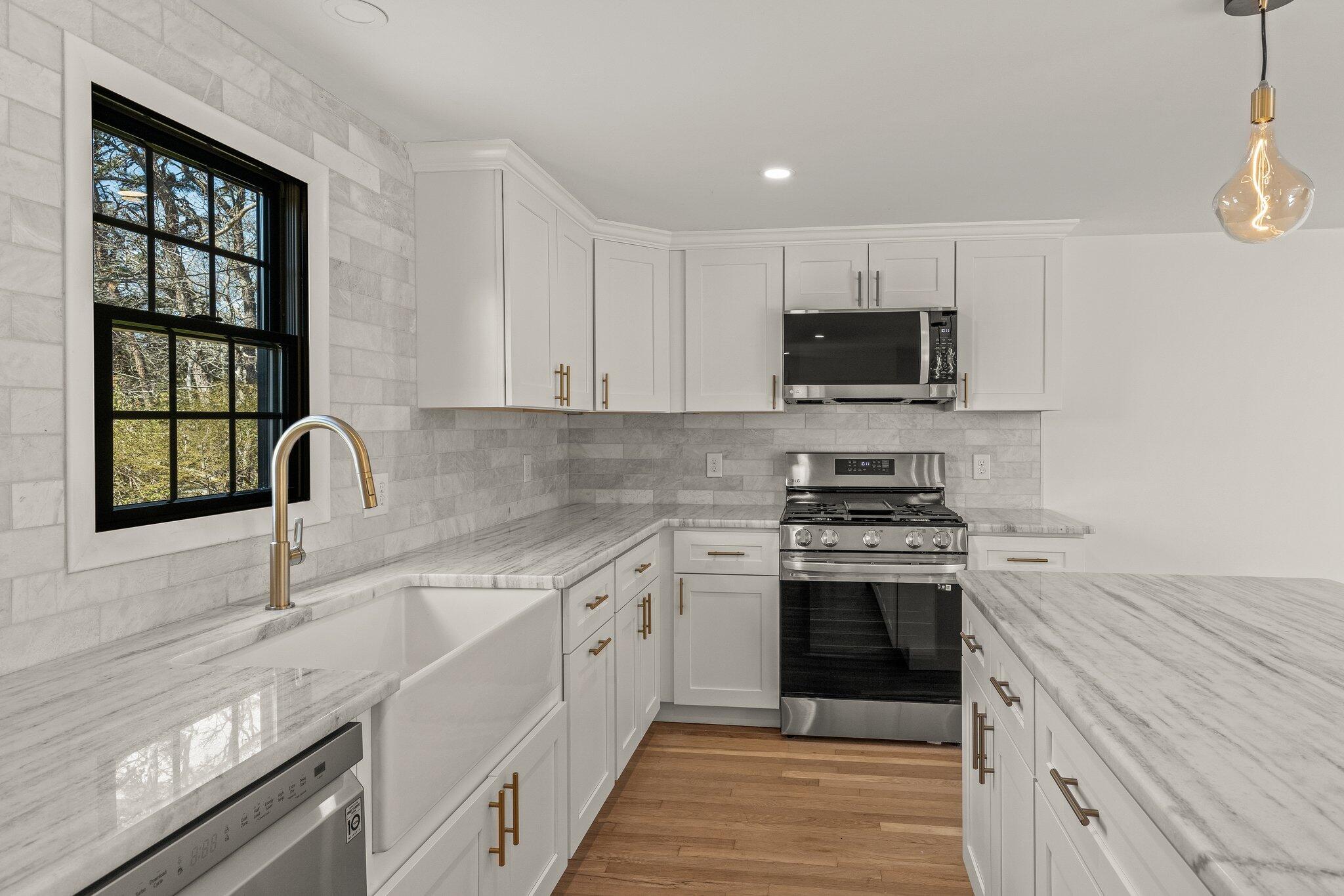 101 Monomoyic Way Chatham, MA 02633 - Photo 9 of 59 a kitchen with stainless steel appliances granite countertop a stove top oven a sink and dishwasher
