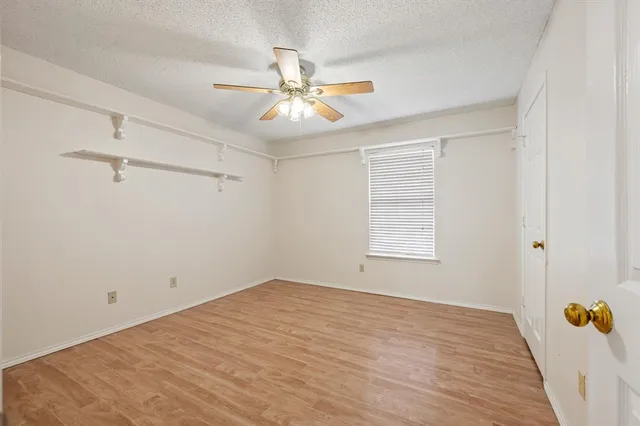 a bathroom with a granite countertop sink a toilet a mirror and shower