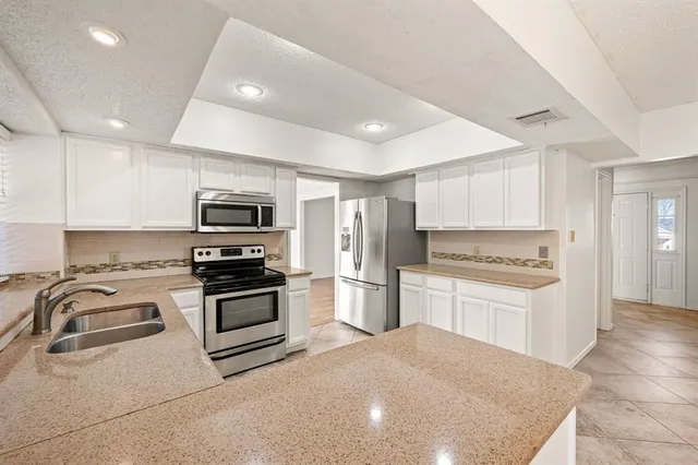 a kitchen with a sink stove and microwave
