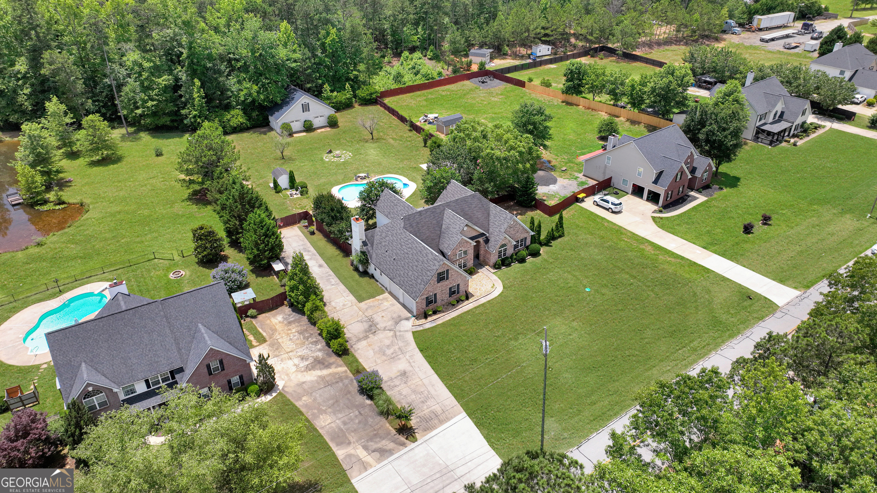 2022 Standing Rock Road Senoia, GA 30276 - Photo 1 of 36 an aerial view of a house with a garden and lake view