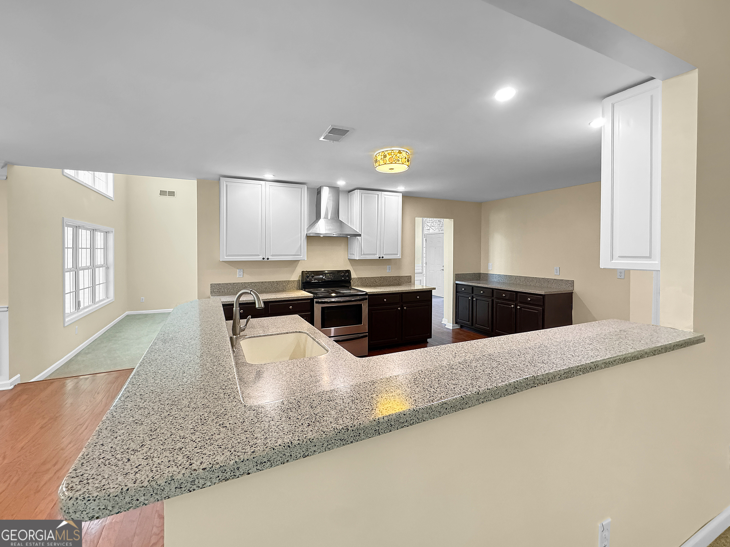 2022 Standing Rock Road Senoia, GA 30276 - Photo 17 of 36 a large kitchen with granite countertop a large counter top stainless steel appliances and cabinets