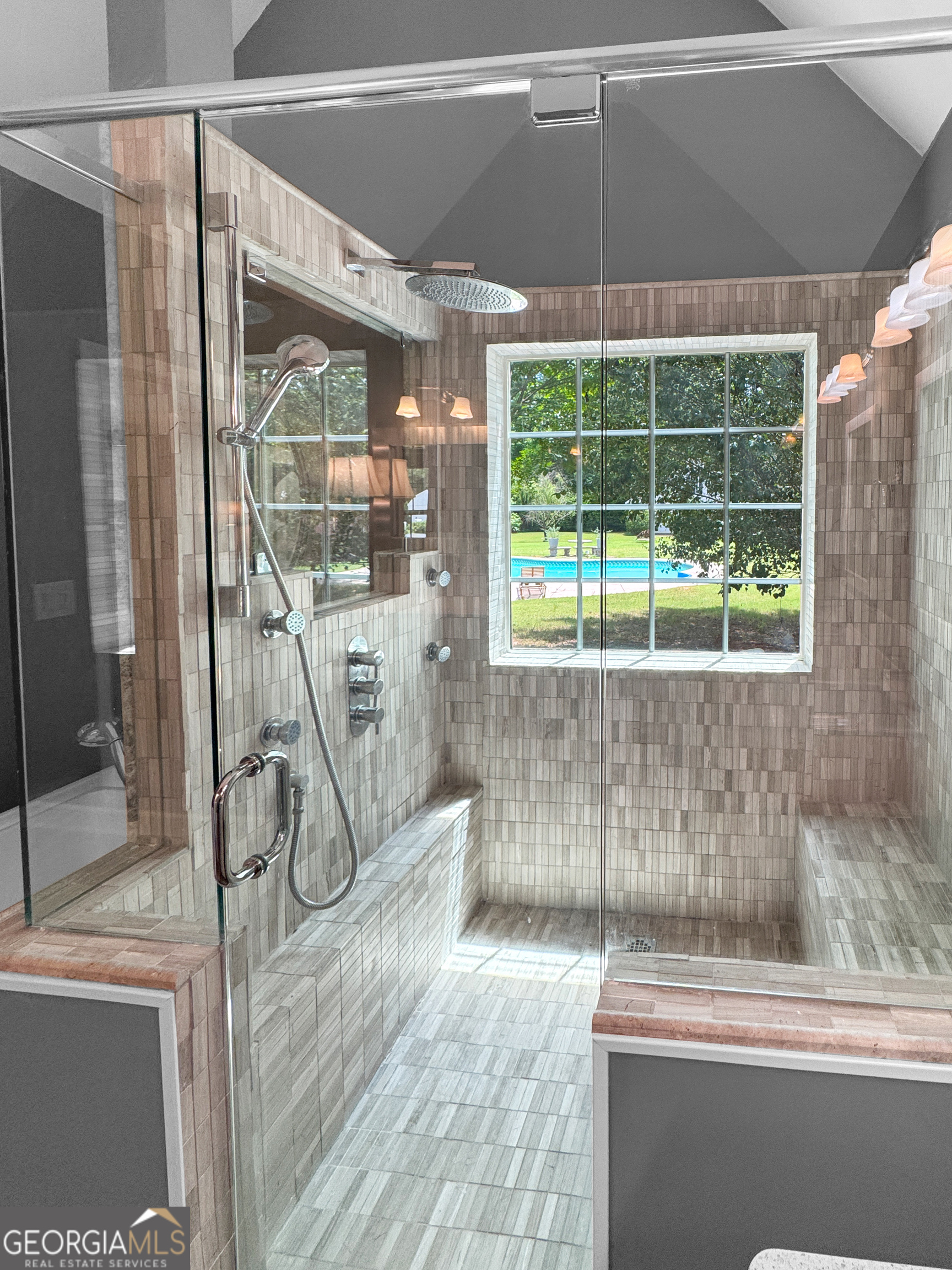 2022 Standing Rock Road Senoia, GA 30276 - Photo 26 of 36 a bathroom with a glass shower door and a window