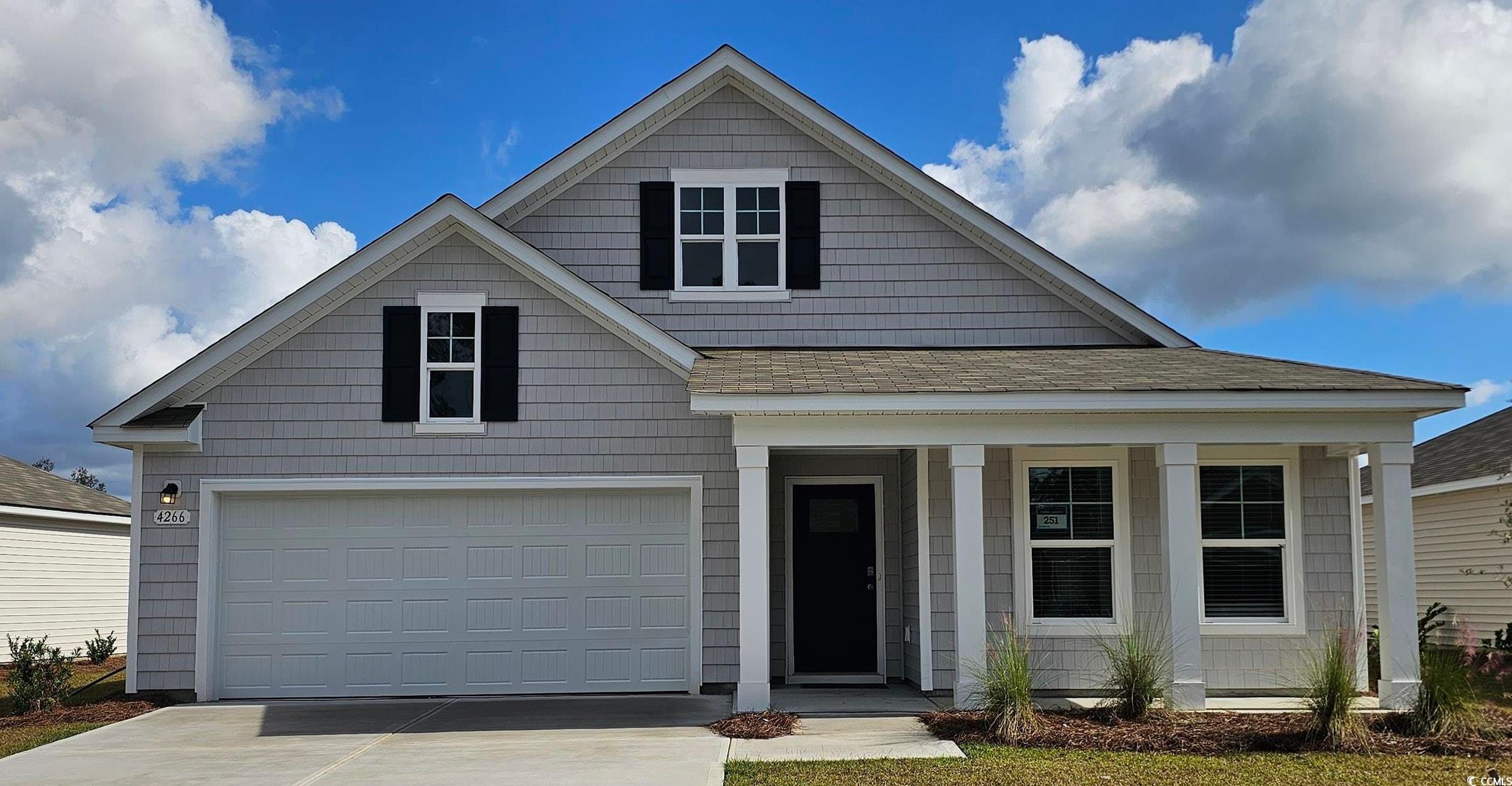View of front of house featuring a shingled roof,