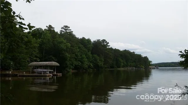 a view of a street sign under a large tree
