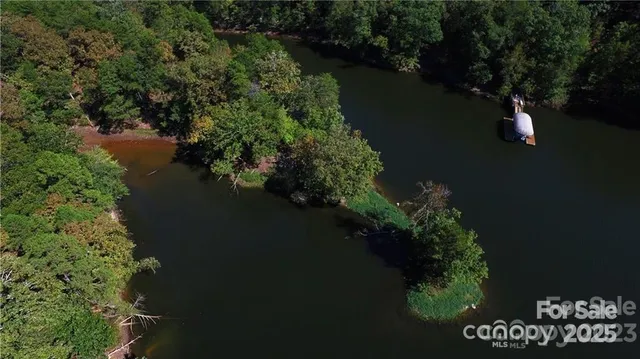 an aerial view of a house with lake view