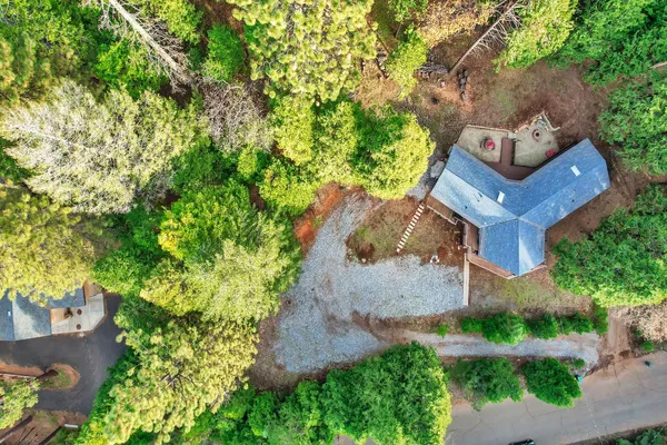 an aerial view of a house with a yard