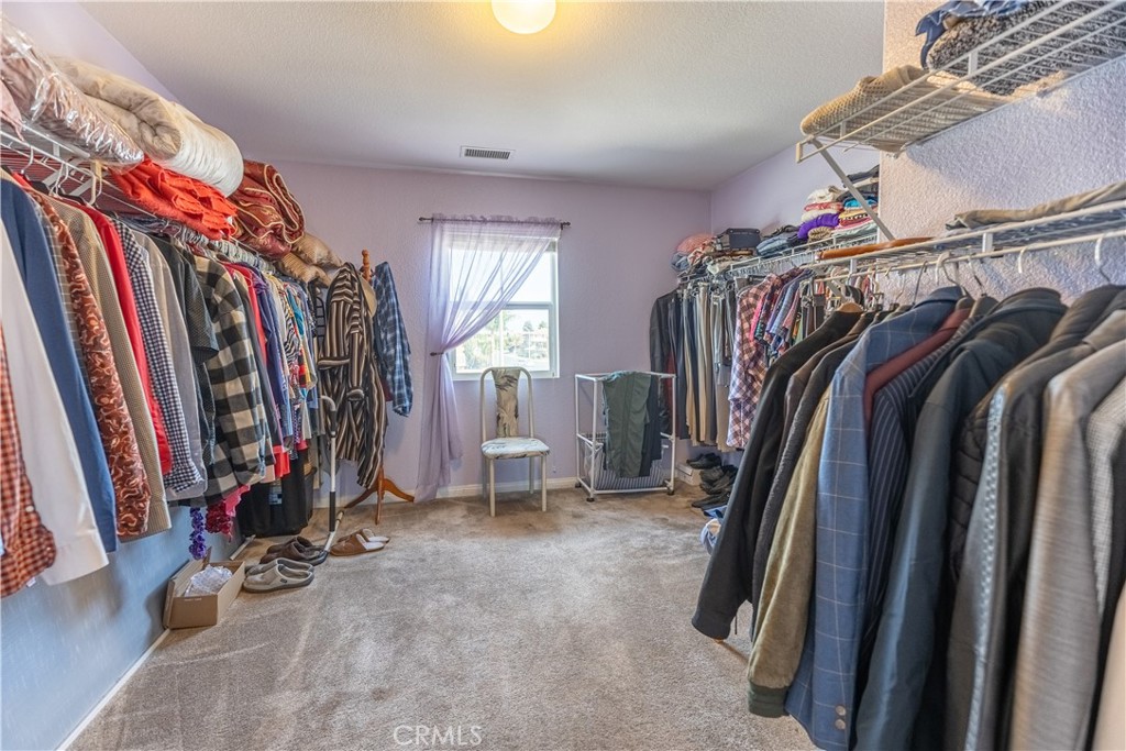 9131 Santa Barbara Drive Riverside, CA 92508 - Photo 11 of 29 a view of walk in closet with clothes and shoes