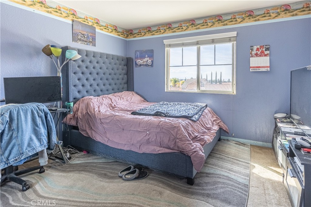 9131 Santa Barbara Drive Riverside, CA 92508 - Photo 14 of 29 a bed sitting in a bedroom next to a window