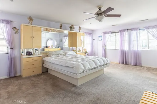 a spacious bedroom with a bed and a window