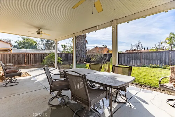 a view of a patio with a table chairs and a couple of chairs