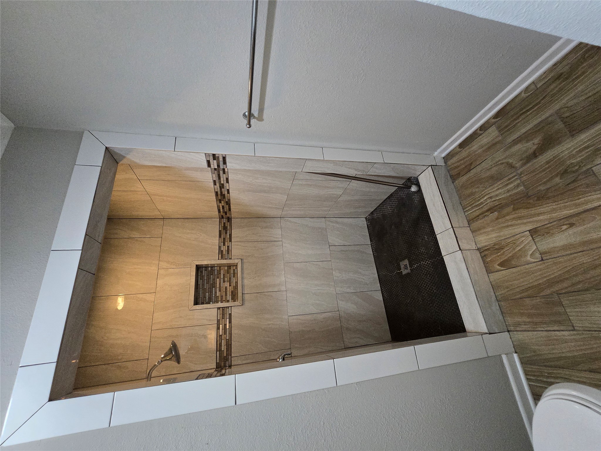 205 East Cherokee Drive Harker Heights, TX 76548 - Photo 16 of 23 Step into this contemporary walk-in shower with sleek tiling and integrated shelving for convenience.
