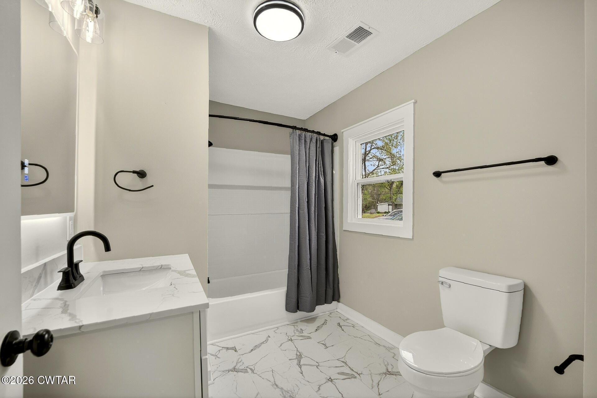 402 Harts Bridge Road Jackson, TN 38301 - Photo 14 of 38 a bathroom with a sink toilet and a mirror