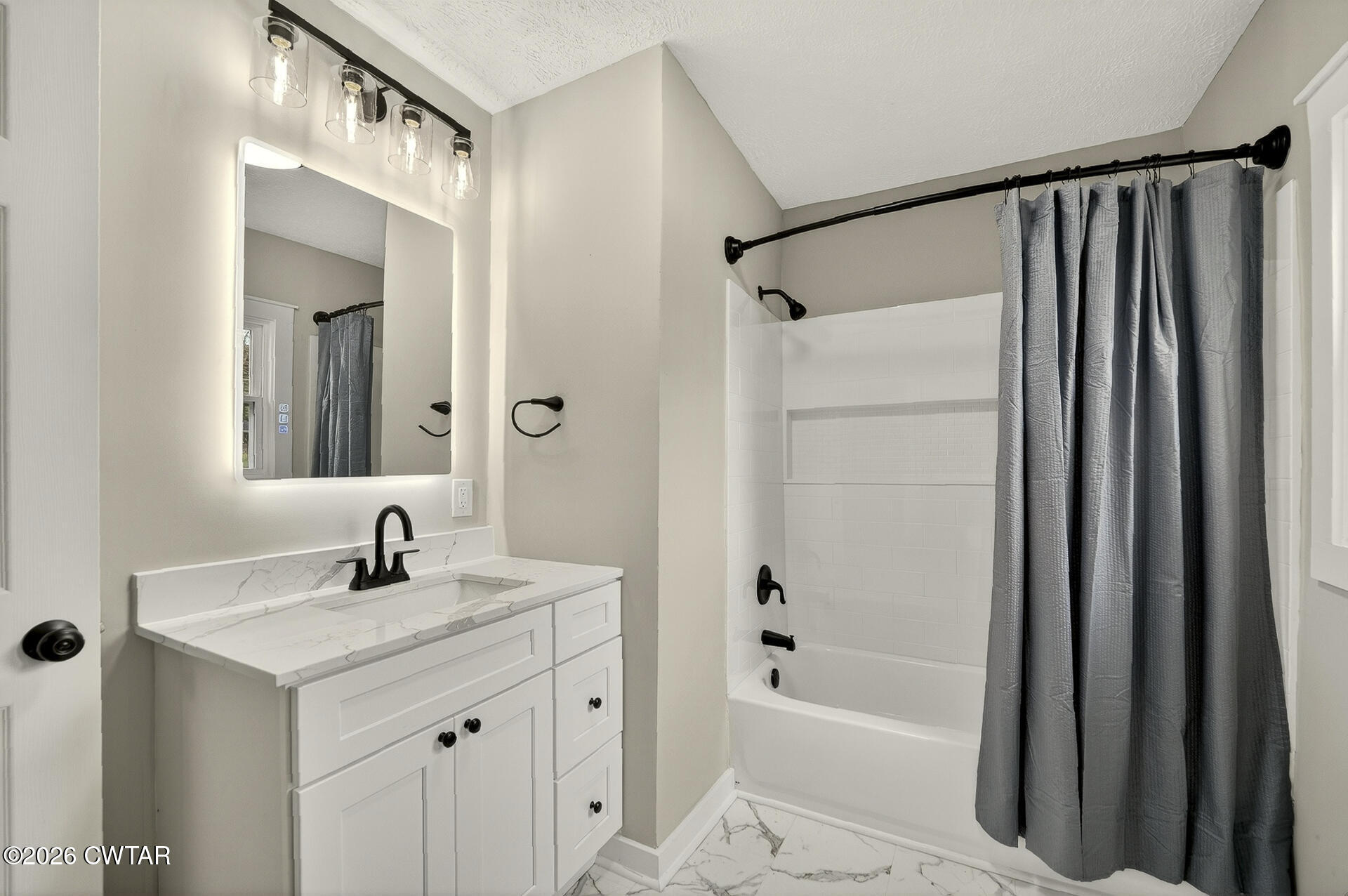402 Harts Bridge Road Jackson, TN 38301 - Photo 15 of 38 a bathroom with a shower sink vanity and mirror