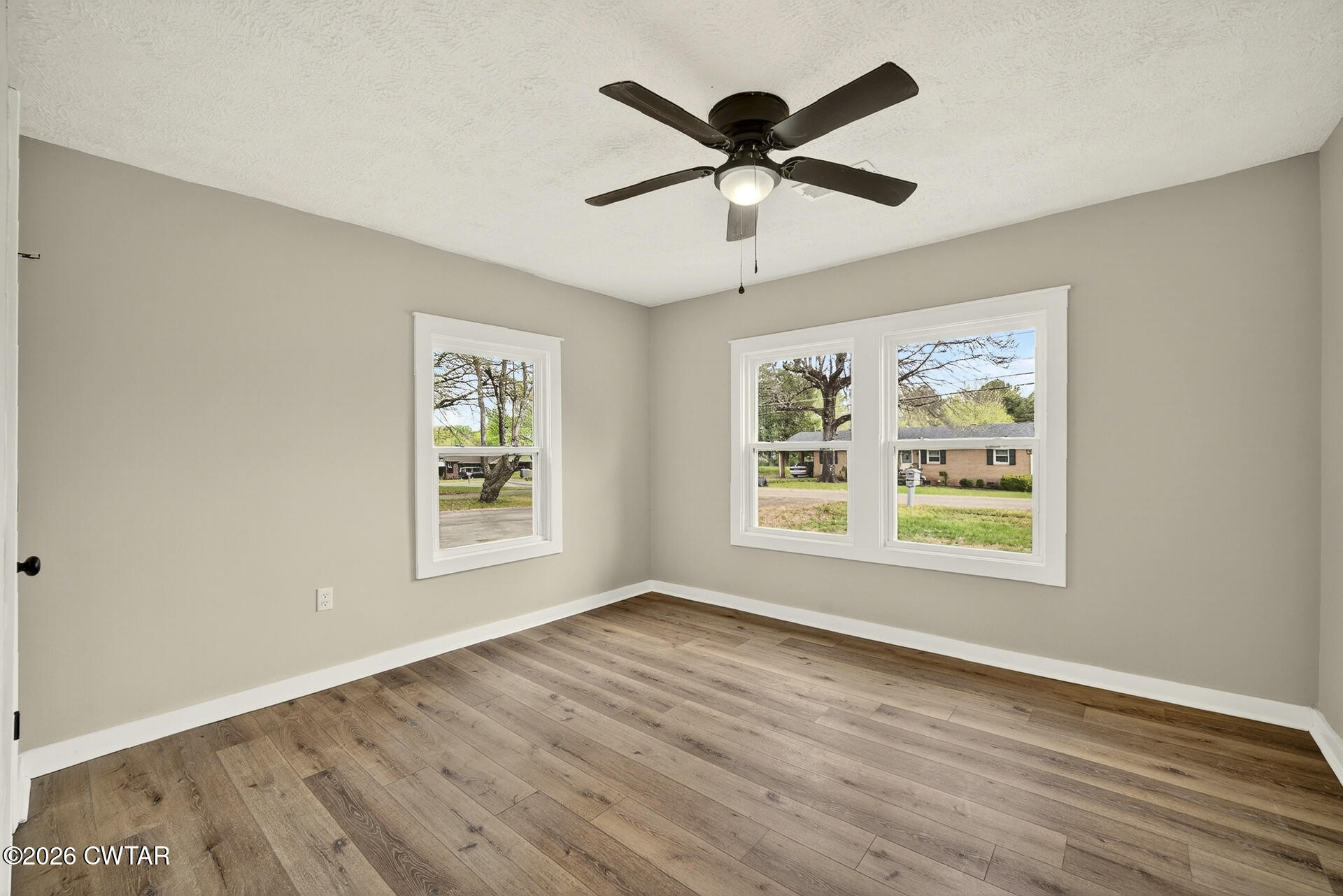 402 Harts Bridge Road Jackson, TN 38301 - Photo 16 of 38 a view of an empty room with wooden floor and a window