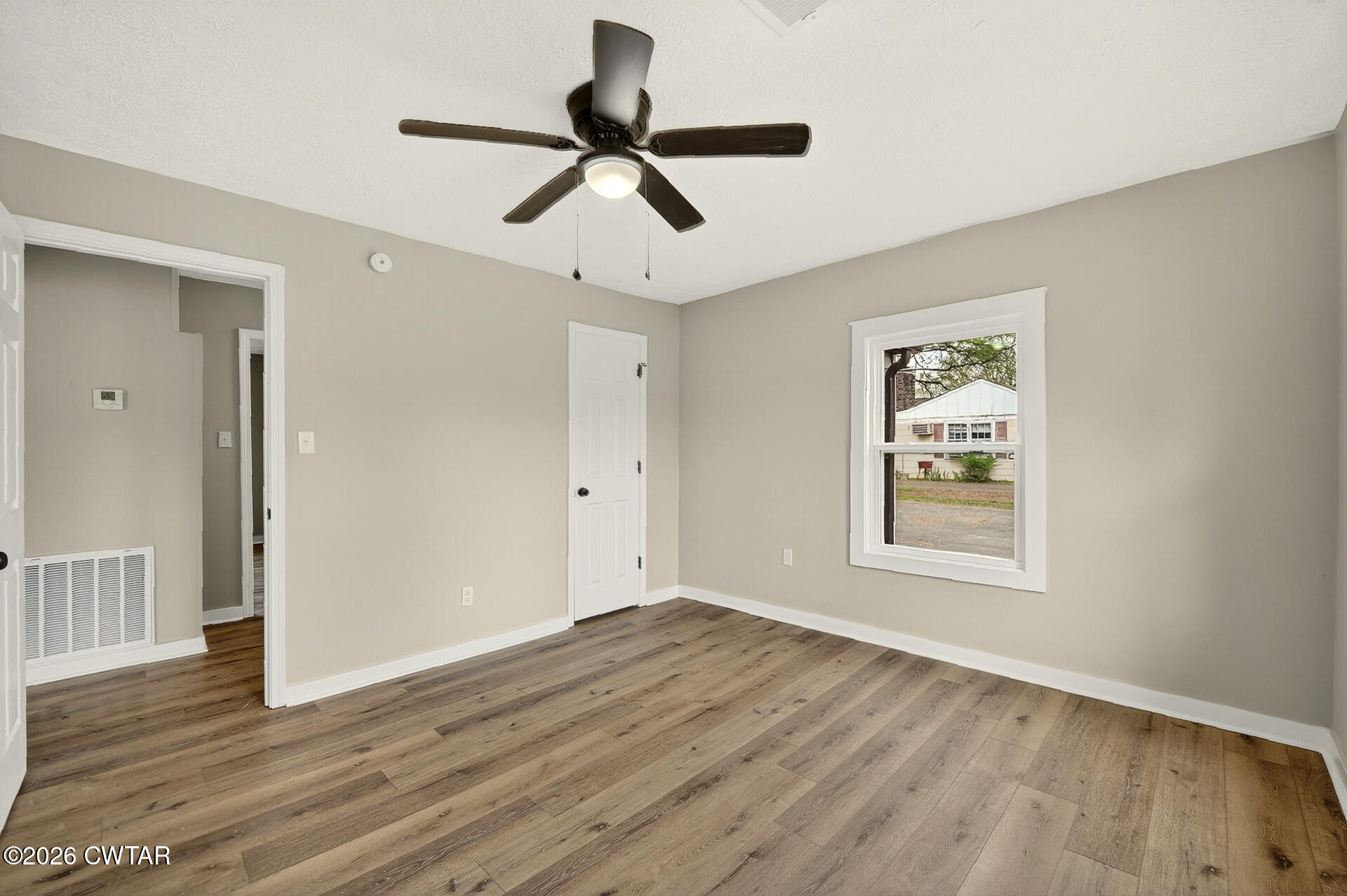 402 Harts Bridge Road Jackson, TN 38301 - Photo 17 of 38 a view of empty room with wooden floor and window