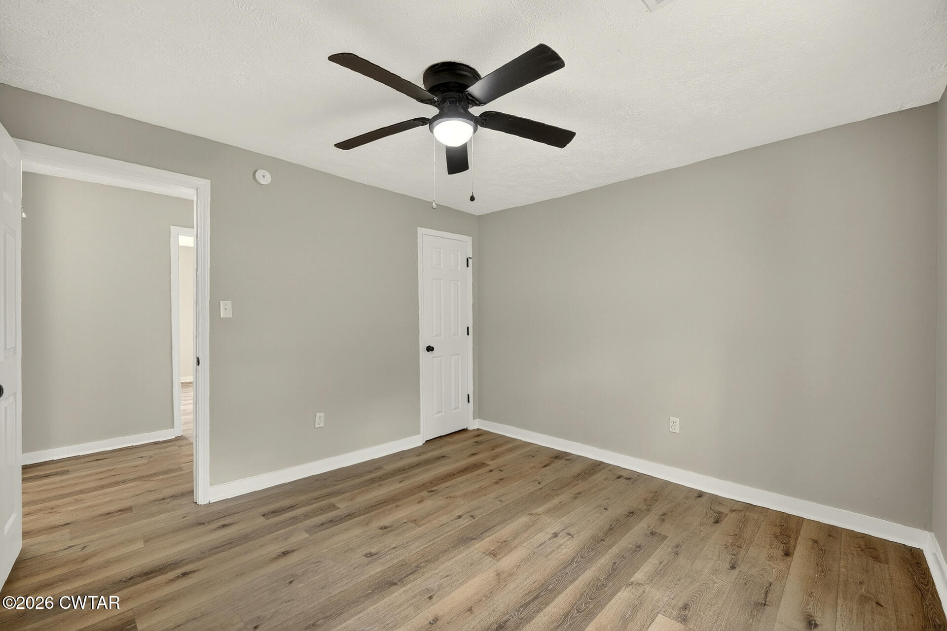 402 Harts Bridge Road Jackson, TN 38301 - Photo 19 of 38 an empty room with wooden floor and ceiling fan