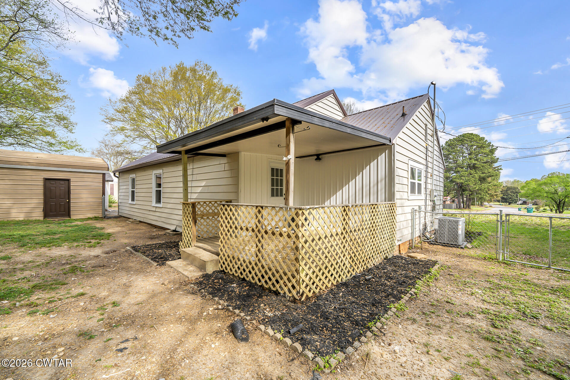 402 Harts Bridge Road Jackson, TN 38301 - Photo 22 of 38 a view of a house with a wooden fence yard