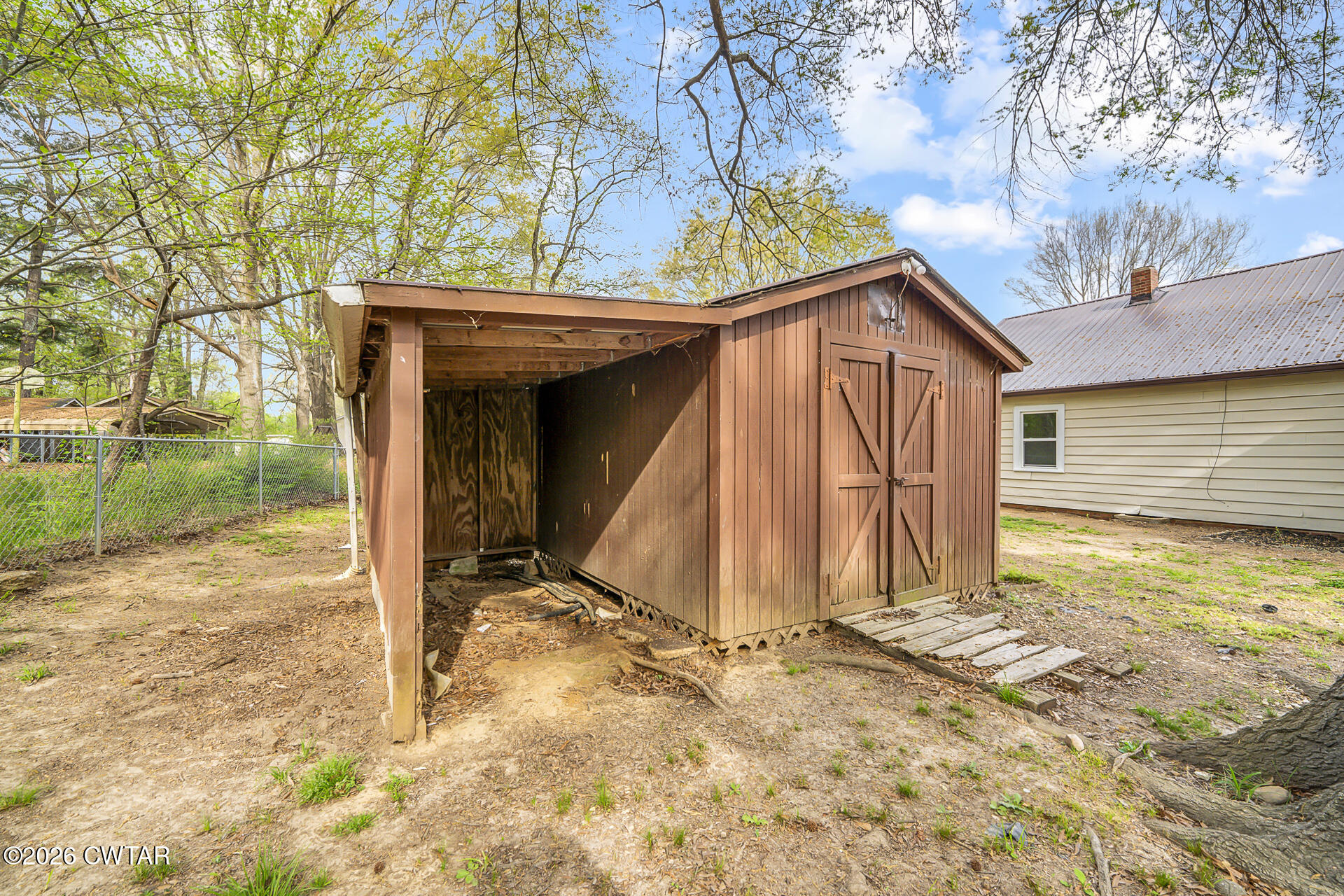 402 Harts Bridge Road Jackson, TN 38301 - Photo 26 of 38 a view of a house with a yard and wooden fence